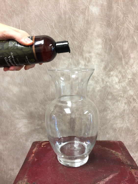 Pouring glycerin into a glass vase.